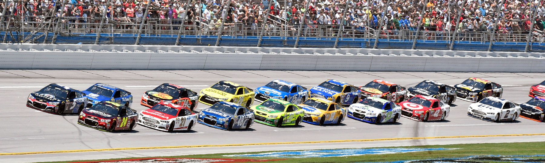 NASCAR cars on racetrack awaiting green flag